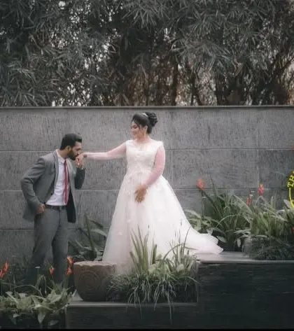 A romantic moment from the same shoot. The groom's grey suit and the bride's white gown create a timeless and elegant combination, perfect for capturing cherished memories.