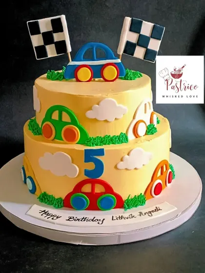 A two-tiered car-themed cake perfect for a little racer's 5th birthday, with colourful cars and racing flags.
