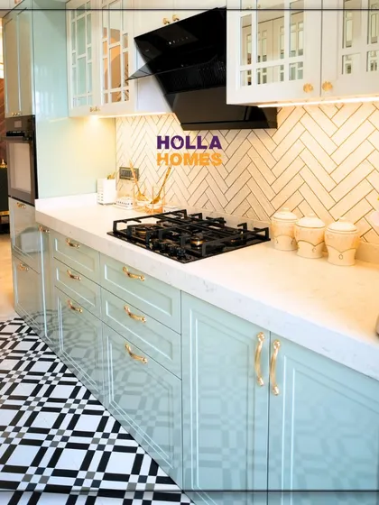 This side of the vintage kitchen features beautiful pastel green PU-coated cabinets and a herringbone tile backsplash.