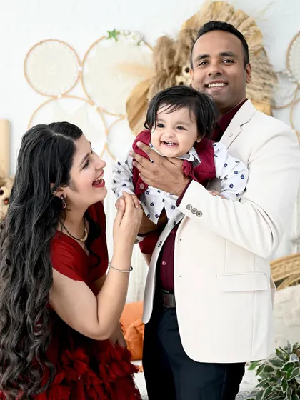 A candid moment of laughter between parents and their baby boy. These unposed shots are often the most cherished memories from a family session.