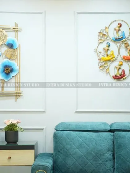 A close-up of the feature wall, showing the beautiful metal art pieces that serve as a focal point. The small Buddha statue and plant add a sense of tranquility to the space.