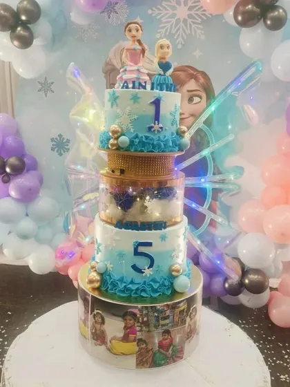 For all the little princes and princesses, I combine the magic of Disney's Frozen with my glowing butterfly wings cake. This multi-tiered creation features Elsa and Anna toppers, snowflake details, and personalized photo panels, making it a dream come true for any fan.
