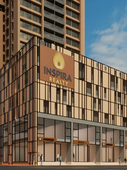 A close-up of the podium level for the Inspira Realty project, highlighting the branding and retail frontage. The facade's geometric pattern and material palette are designed to create an attractive and modern street-level experience for shoppers and residents.