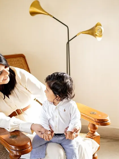 Using the beautiful golden light streaming through the window for a mother and baby portrait. Your home provides the perfect, meaningful backdrop for photos.