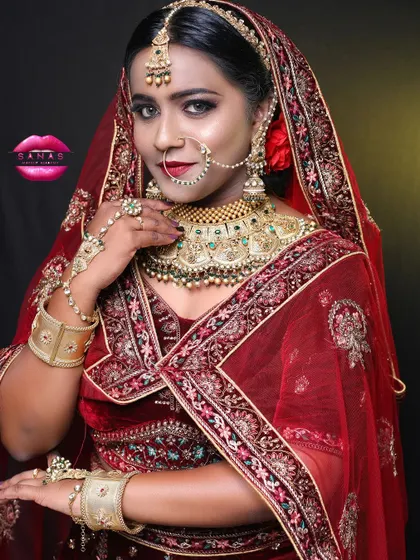 This shot captures the complete royal bride ensemble. The heavy jewellery, the rich velvet lehenga, and the confident pose all contribute to a look of regal elegance.