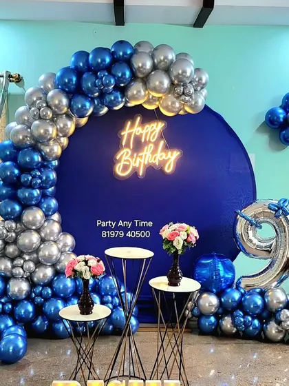 A close-up of the balloon arch and backdrop for the 9th birthday party.