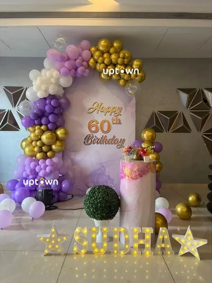 Another view of the 60th birthday setup, showing the light-up name and balloon arch.