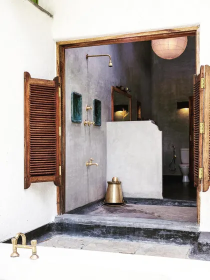 The semi-outdoor shower of the Garden Suite, which opens into the private courtyard, offering a unique bathing experience.