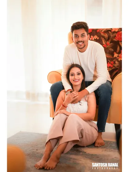 A relaxed and happy indoor portrait of a couple, showcasing a cozy and intimate atmosphere.