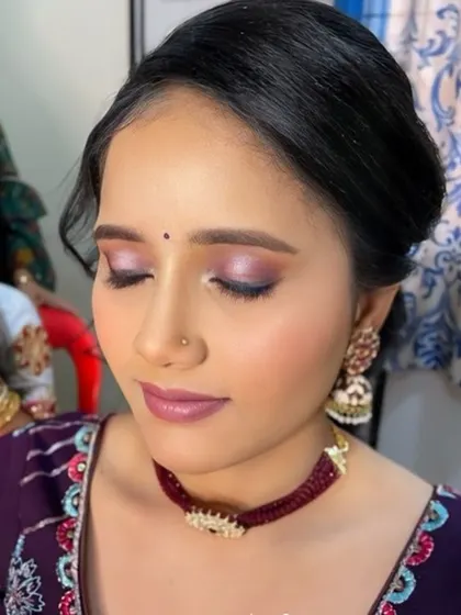 A soft, romantic makeup look with purple and pink tones. This is a great option for a bridesmaid or wedding guest.