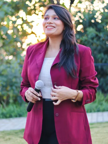 Mic in hand, ready to engage. This photo was taken while hosting an event for HDFC Bank at Hyatt Regency Dehradun, where I combined formal hosting with interactive sessions.