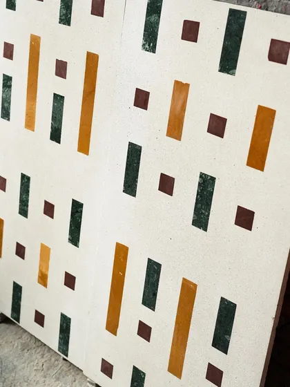 An angled view of the geometric Venetian terrazzo tiles, showing how the pattern creates a sense of rhythm and movement.