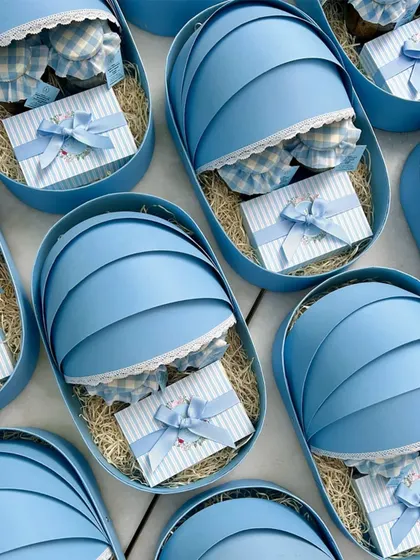 An array of our blue cradle hampers, meticulously prepared for a bulk order to announce the arrival of a baby boy.