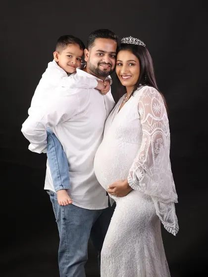 Another angle of this happy family, showing the strong bond and excitement. These family maternity portraits are about creating memories for everyone.