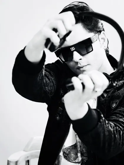 A black and white shot from a recent photoshoot. My headphones are my most important tool, connecting me to the music and the crowd.