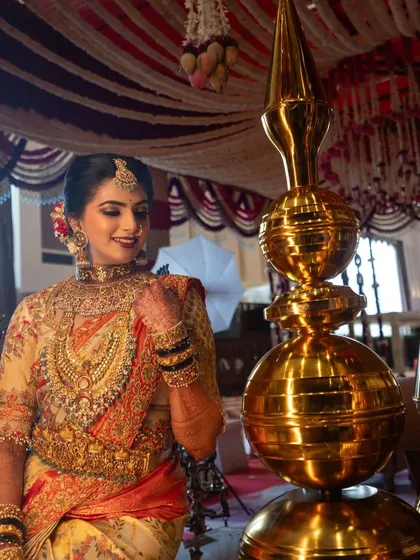 Jhanvi amidst the beautiful decor of her wedding, looking absolutely stunning. Her traditional saree and heavily embroidered blouse make for a picture-perfect bridal moment.