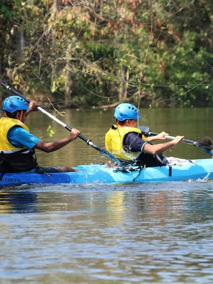 Two guests enjoy a peaceful paddle in a two-person kayak. It's an ideal way to experience the tranquility of the water at your own pace.