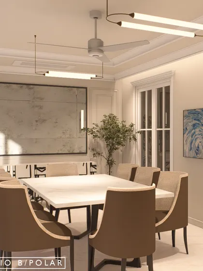 The formal dining room is defined by its clean lines, neutral palette, and modern lighting. A large, distressed mirror adds a sense of scale and reflects light, making the space feel bright and open.