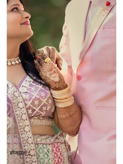 A detail shot focusing on the bride's hand on her groom's arm, a simple gesture that speaks volumes about their connection.