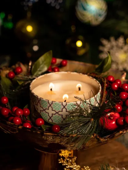 A close-up of our festive three-wick candle, creating a warm and inviting glow. It's a perfect centerpiece for your holiday table or a thoughtful gift for a loved one.