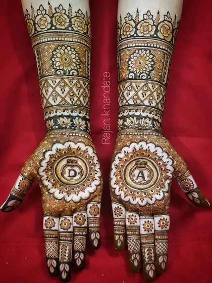 A beautiful and intricate design for a ring ceremony, featuring the couple's initials inside a decorative ring motif. This video shows the fine details and the love that goes into every stroke.