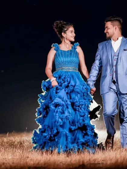 A romantic night shot where the couple's matching blue outfits, both provided by me, create a cohesive and elegant look. Groom styling is a key part of my service.