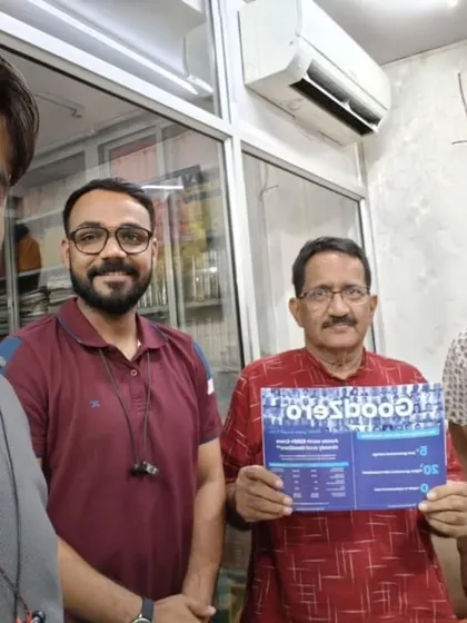 Our team with a customer holding our "GoodZero" brochure.