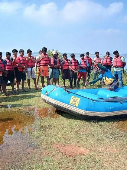 Another angle of our instructor demonstrating rafting basics to an attentive group of students on the shore.