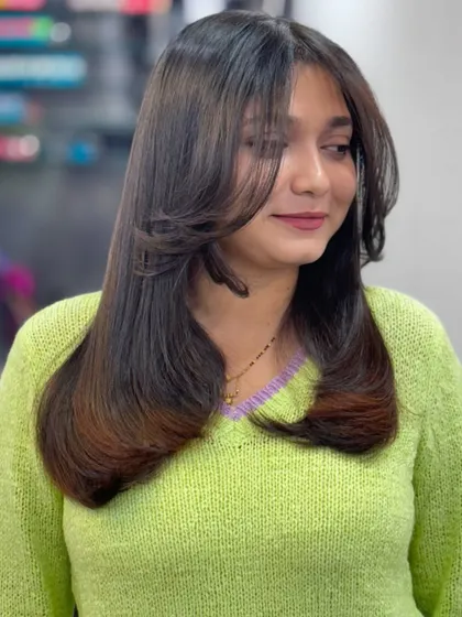 Self love is the best love, starting with your hair. This layered cut with curtain bangs is chic and stylish.
