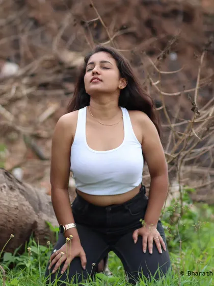 A relaxed, kneeling pose in a natural setting. This kind of lifestyle shot is about capturing authentic moments and expressions.
