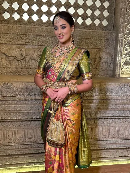 A full-length shot against a traditional backdrop, showing how the entire look comes together.