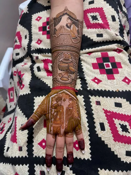 This full-hand design combines multiple wedding scenes. The palm features a varmala ceremony portrait, while the arm depicts a bride in her doli and other traditional wedding symbols.