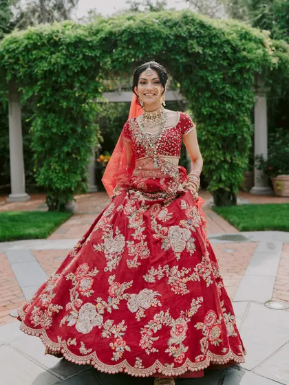 A radiant smile is the best accessory. This bride looks absolutely joyful and confident in her classic red lehenga, ready for her big day.