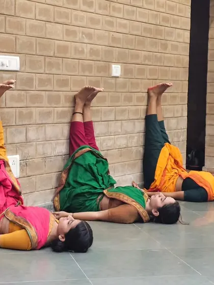 Cooling down after a rigorous practice session. These exercises are just as important as the dance itself for maintaining a healthy and strong body.