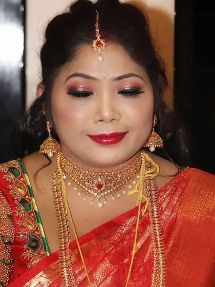 Two different expressions from the same client, Sowmya, showing how the makeup looks beautiful both when she is smiling and when she is posing.