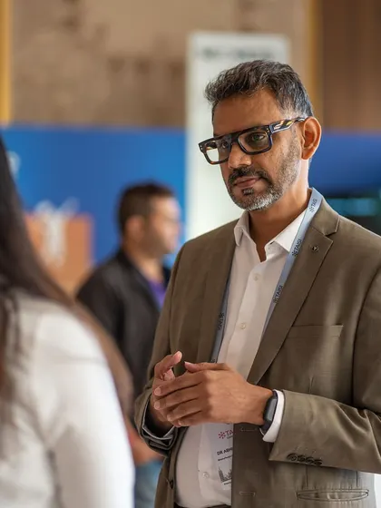 Meaningful conversations happen in the spaces between sessions. Here, I am in a one on one discussion with a conference attendee, exploring how to implement parent partnership programs effectively within school systems.