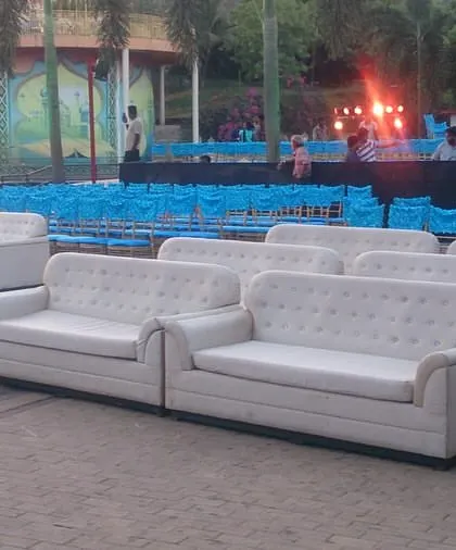 The VIP seating area at the Sangeet Sandhya, featuring comfortable white sofas for close family and friends to enjoy the performances.