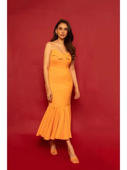 The full view of the orange RSR dress. The fitted bodice and flared hem create a beautiful, feminine silhouette.