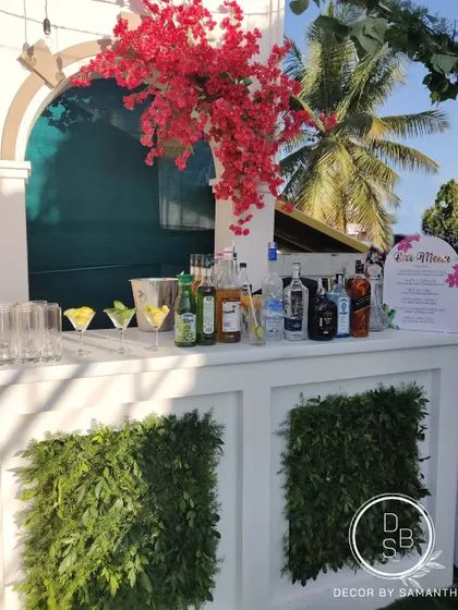 Setting the bar high, even for an intimate gathering. This simple yet elegant bar setup was decorated with bright bougainvillea and a custom menu.