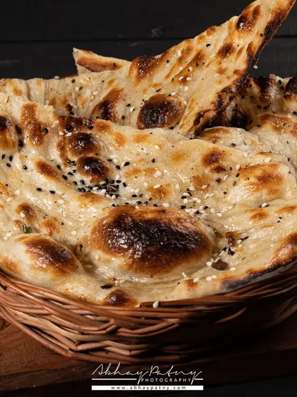 Another variation of Indian bread, this time with sesame seeds. I arrange them in a basket to give a sense of abundance, as if they've just come out of the tandoor.