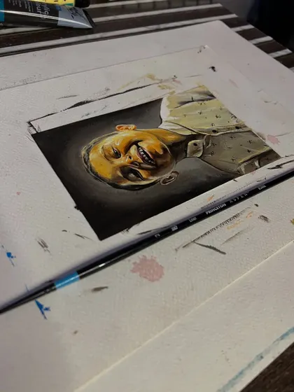 The portrait on my desk. I use fine brushes to paint these miniature pieces with as much realism as possible.