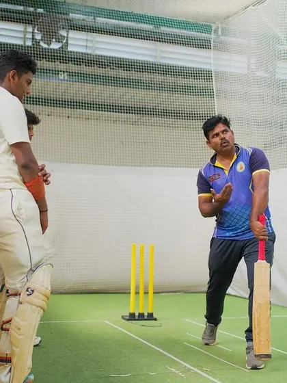 A coach provides batting instruction in the indoor nets. We believe in breaking down every movement to build a strong technical foundation.