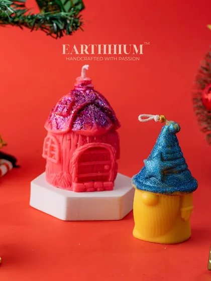 A festive set of two Christmas candles, a gnome and a little house, ready to be gifted.