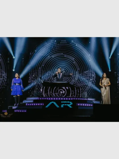A.R. Rahman performing with his backup singers against a mesmerizing digital backdrop. This photo captures the scale and artistry of the concert production.