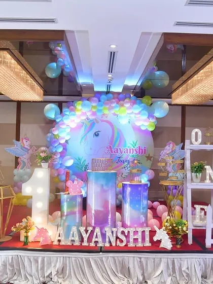 This unicorn-themed birthday party is filled with pastel colors and sparkle. I created a full stage setup with unicorn cutouts, a rainbow balloon backdrop, and a white picket fence for a magical touch.
