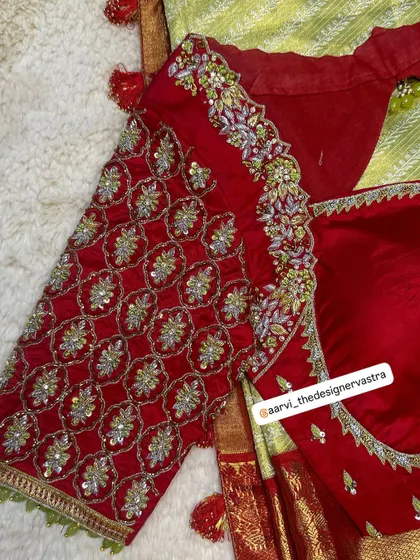 A close up of the sleeve of the red bridal blouse. The intricate pattern work is a testament to the skill of my artisans.