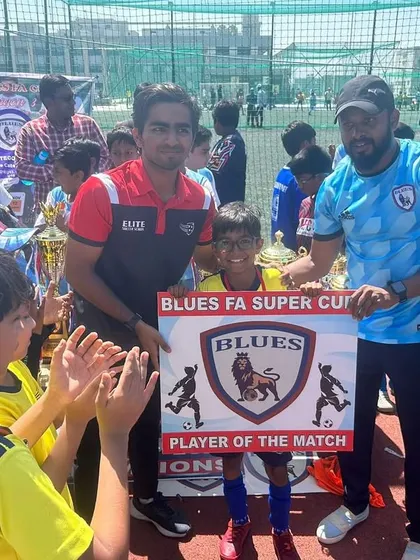 A player receiving the "Player of the Match" award at the Blues Super Cup. We celebrate individual brilliance within the team context.