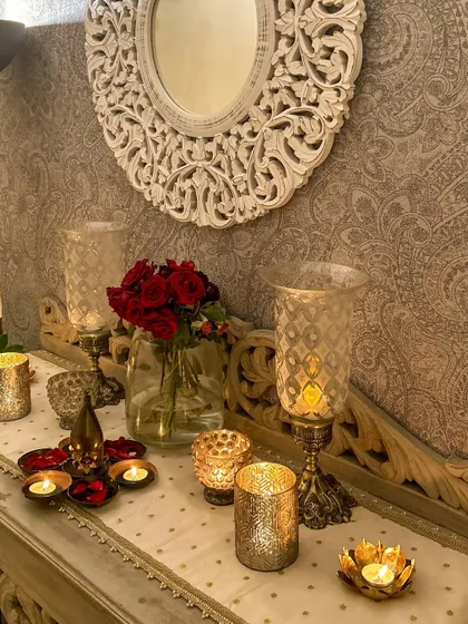 A closer look at the candlelit foyer. The red roses and gold-toned candle holders add a touch of romance and elegance.