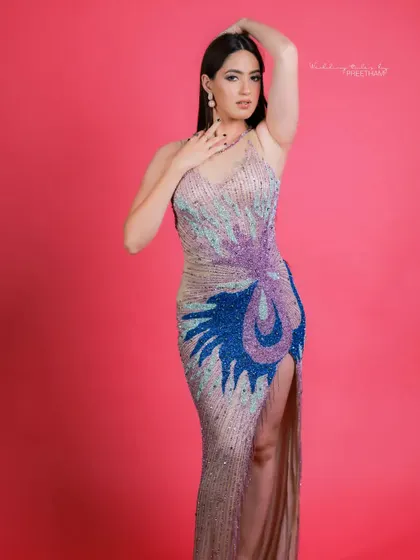 Another view of the artistic, multi-colored gown, showing off the thigh-high slit and the intricate beadwork that makes it so special.