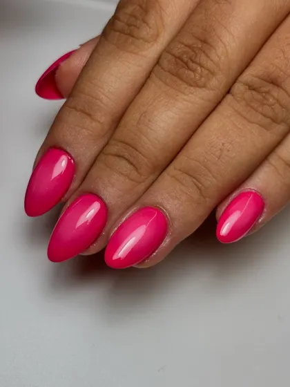 A finished set of stunning pink ombre nails created using an airbrush. This technique achieves a seamless color gradient that is difficult to replicate by hand, and it is a popular request for modern manicures.